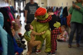 students hugging the Grinch