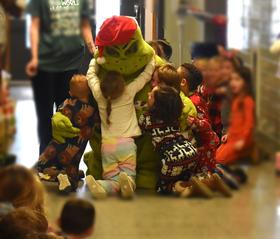 students hugging the Grinch